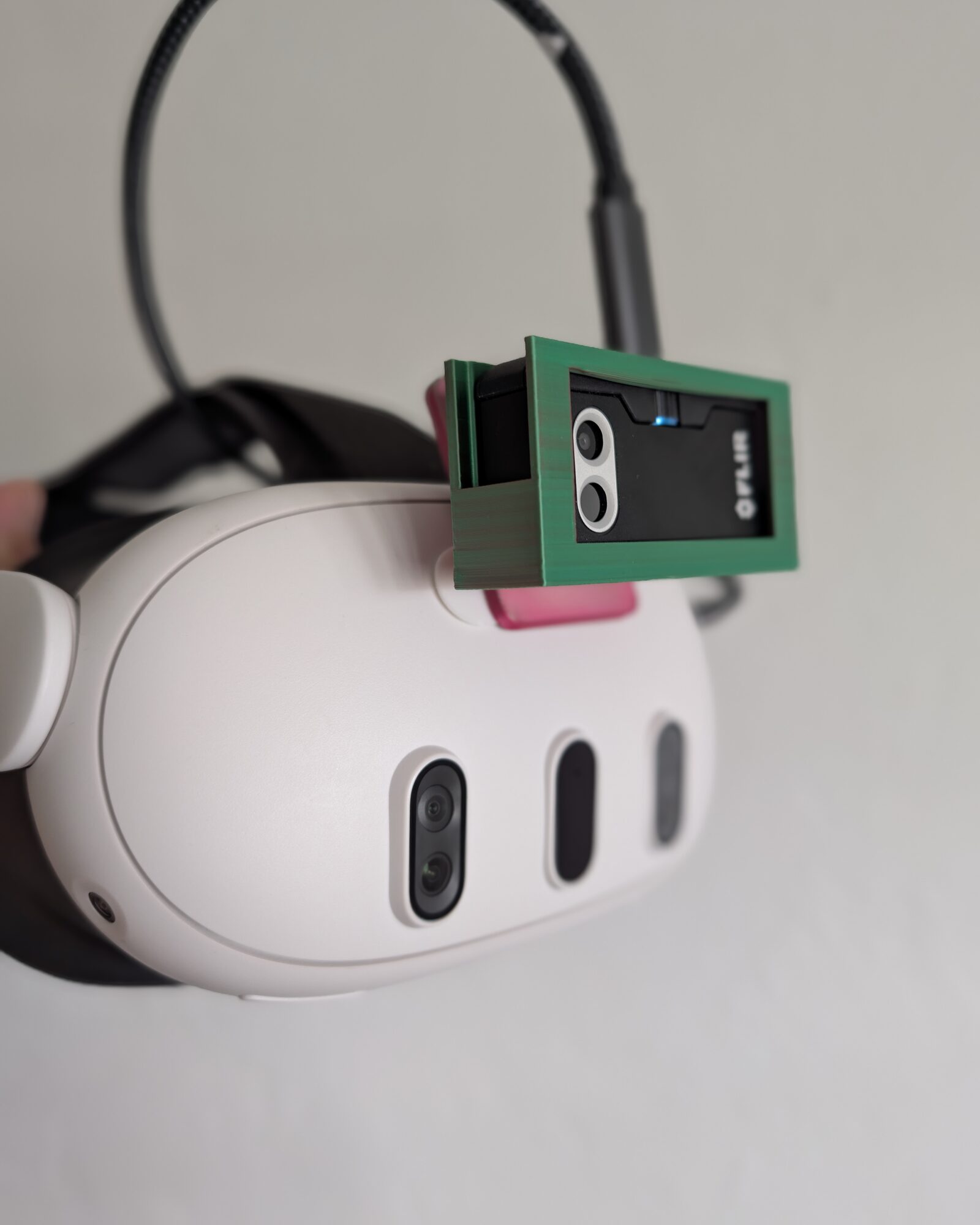 FLIR One Pro thermal camera in the 3D-printed ThermaSpace mount on top of a Meta Quest 3 headset, seated with a Command strip